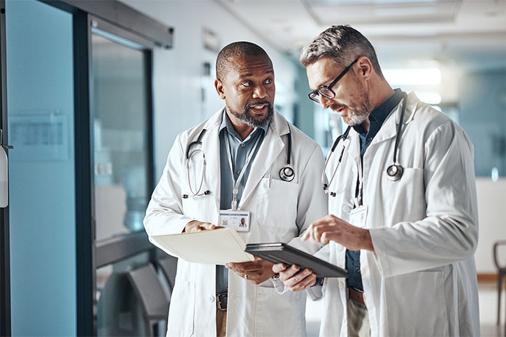 two doctors discuss care two doctors discuss medical care in a hospital