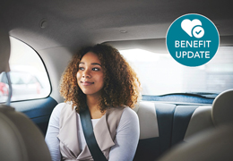 A photo of a woman in the back seat of a car