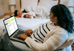 A photo of a woman using a laptop